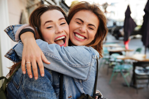 friends hugging each other and laughing