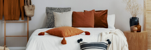 decorative pillows on a bed